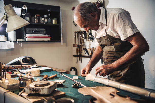 istock Senior entrepreneur repairing music instruments 828935142