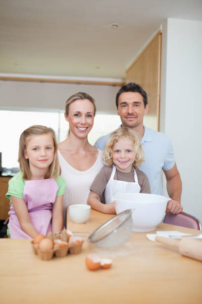 istock Happy smiling family preparing cookies 828940432