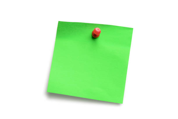 istock Green paper note pad attached with push pin isolated on white background 828941354
