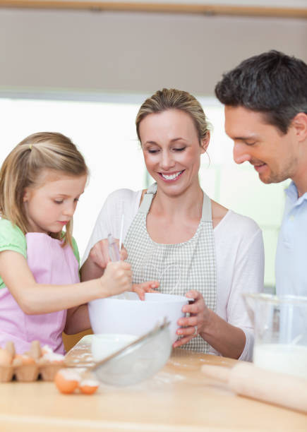 istock Family preparing cookies together 828941424
