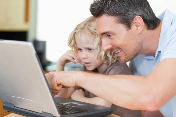 istock Father showing his son the internet 828942528