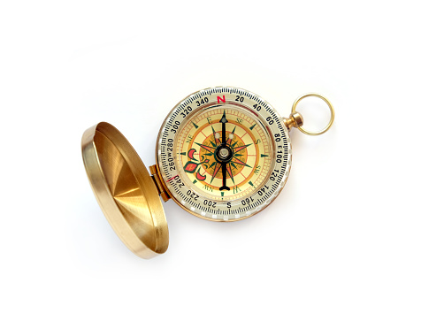 Vintage compass in opened brass case on isolated on white shown to North direction top view close up