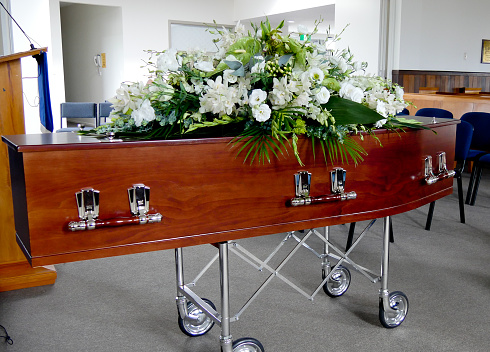 closeup shot of a colorful casket in a hearse or chapel before funeral or burial at cemetery