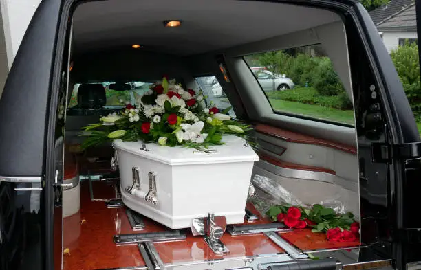 Photo of a colorful casket in a hearse or chapel before funeral or burial at cemetery