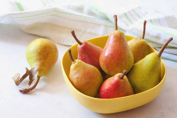 istock Plate with juicy ripe yellow-red pears on a white background 828985722