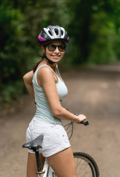 istock Happy woman mountain biking 828991528