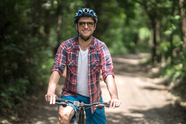 istock Happy man mountain biking 828991694