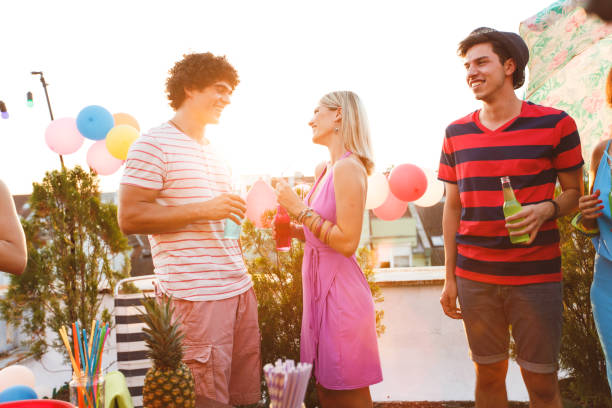 istock Couple flirting on roof party 829006264