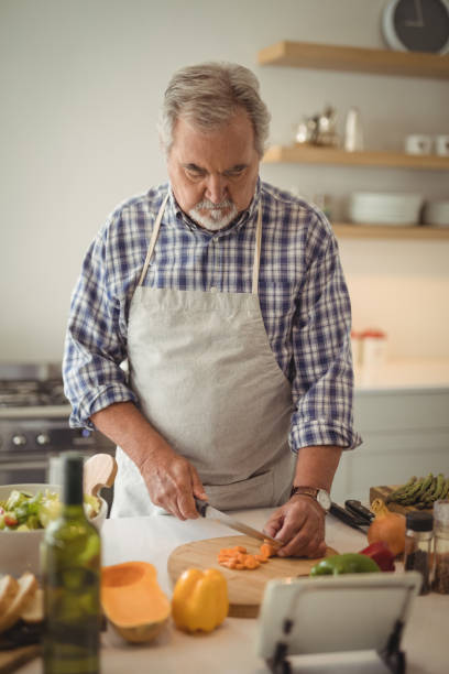 istock Senior man chopping vegetables 829038858
