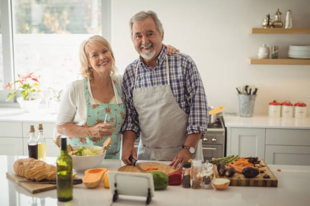 istock Senior couple preparing meal in kitchen 829039162
