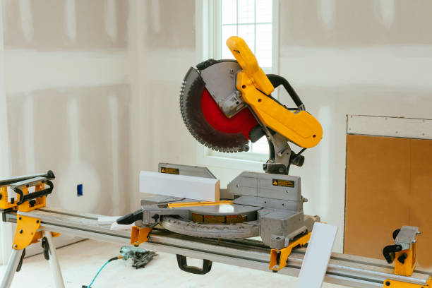 istock Carpenter cutting wooden plank with circular saw wearing safety 829042500