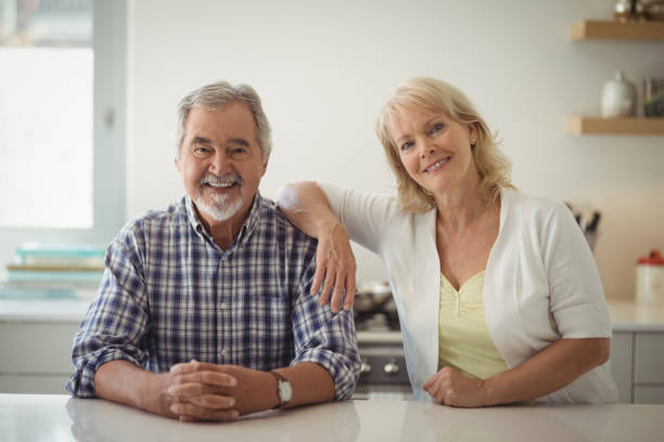 istock Senior couple sitting in the kitchen 829075328