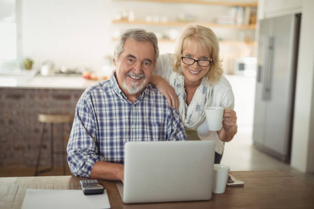 istock Senior couple using laptop at home 829082518