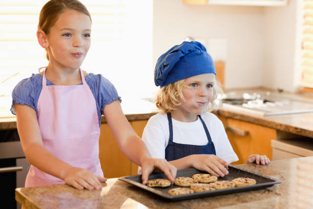 istock Siblings enjoying cookies together 829112222