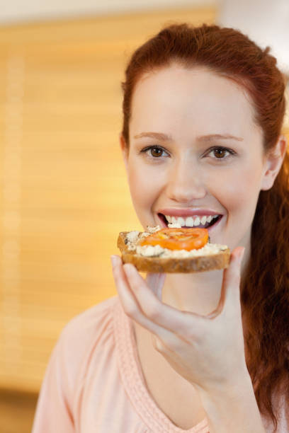 istock Woman having a slice of bread 829113900