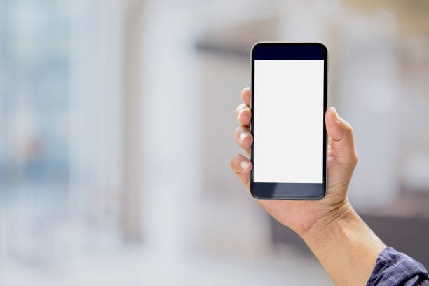 istock Mock up Smartphone : Business man hands holding mobile phone with abstract bokeh background. 829120720