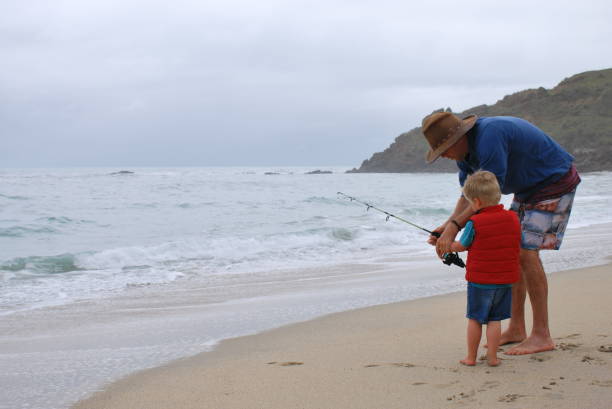 istock Man and Boy Surf Fishing in Summer 829139472