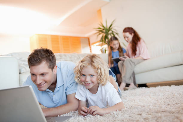 istock Father and son with laptop on the floor 829164232