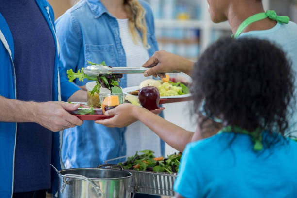 istock Volunteers serve healthy meal in soup kitchen 829171114
