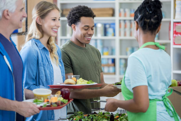 istock Young couple receive meal in soup kitchen 829171118