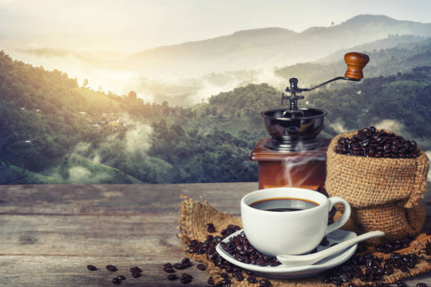 istock Cup of coffee and coffee beans on table 829178916