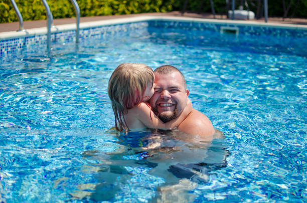 istock Father with daughter in the swimming pool 829190484
