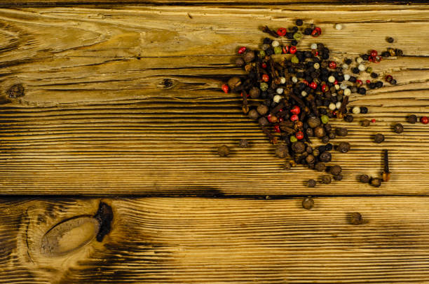 istock Different pepper spices on wooden table. Top view 829197958