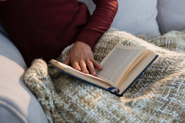 istock Mid section of woman with book 829204586