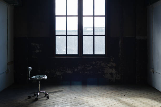 istock Lone chair in an emply old room 829205072
