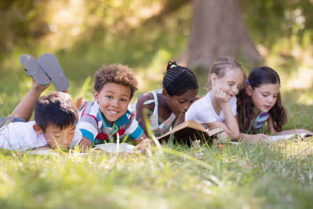 istock Group of friends reading book at campsite 829210390