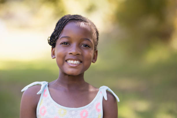 istock Smiling girl standing in forest 829211422