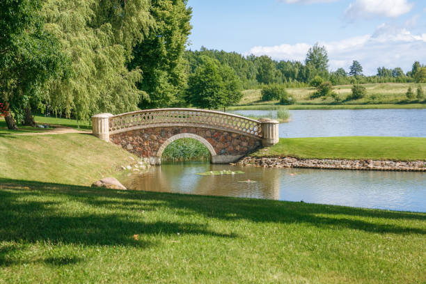 istock Old park with bridge and island. 2017 Latvia, Rumene. 829212494