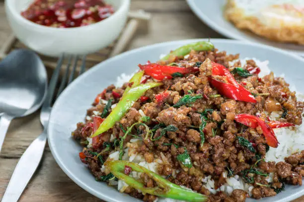 Photo of Close-up Hot Rice topped with stir-fried pork and basil food of thailand.