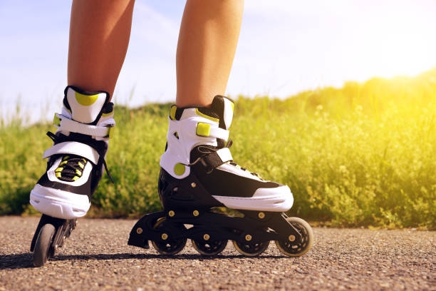 istock Female legs in inline skates in action outdoors on sunny day. 829227518