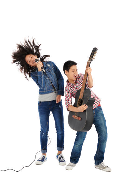 Singing siblings Cheerful siblings performing together, isolated on white juvenile musician stock pictures, royalty-free photos & images