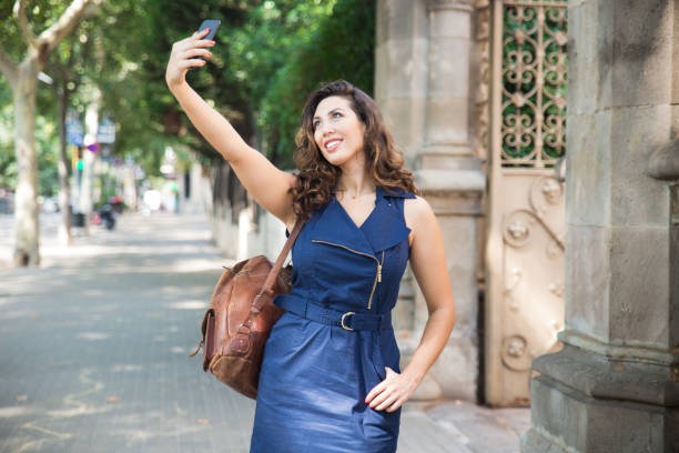 istock Cheerful young woman taking selfie at ancient gate 829246822