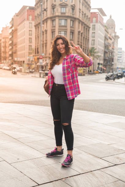istock Cheerful young woman showing two fingers 829247258