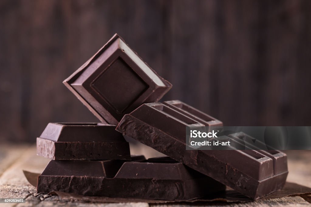 Dark chocolate stack, on wooden table,chocolate concept background Chocolate Stock Photo