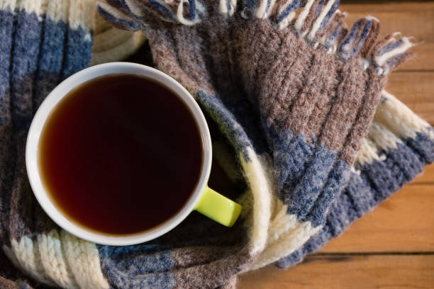 istock Overhead view of black coffee amidst scarf 829259804