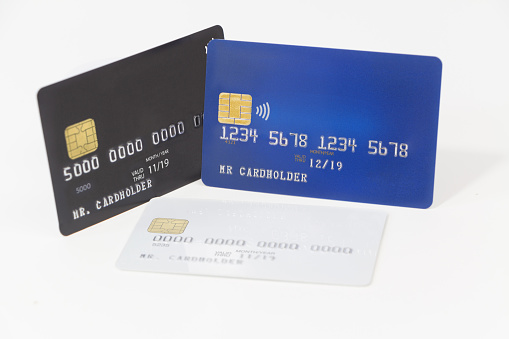 Blue, white and black credit cards on white background, banking and shopping
