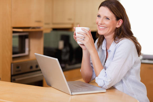 istock Woman with cup and notebook in the kitchen 829264716