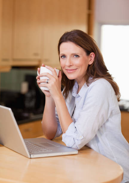 istock Woman with laptop and a cup 829264844