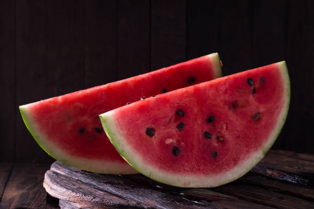 istock watermelon and watermelon pieces in a wooden background. 829266342