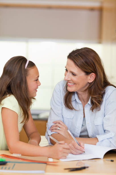 istock Woman doing homework with her daughter 829274192