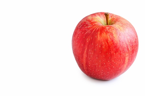 A close up shot of a fresh organic Royal Gala apple on white background.