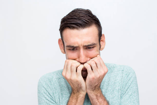 istock Closeup of Nervous Young Man Biting Nails 829280482