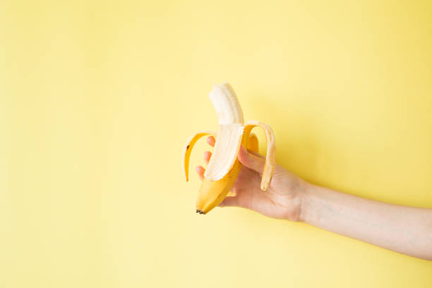 istock Human Hand Holding Banana Fruit Nutrition Concept 829282164