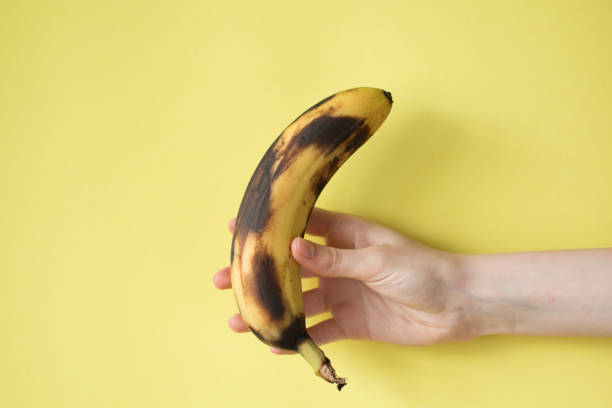 istock Human Hand Holding Banana Fruit Nutrition Concept 829282244