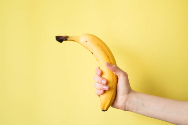 istock Human Hand Holding Banana Fruit Nutrition Concept 829282410