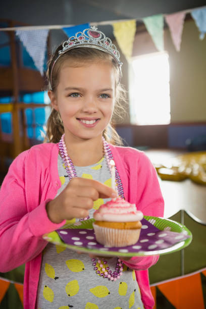 istock Birthday girl holding a cupcake 829301882